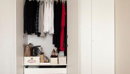 a neat and organized closet with clothes